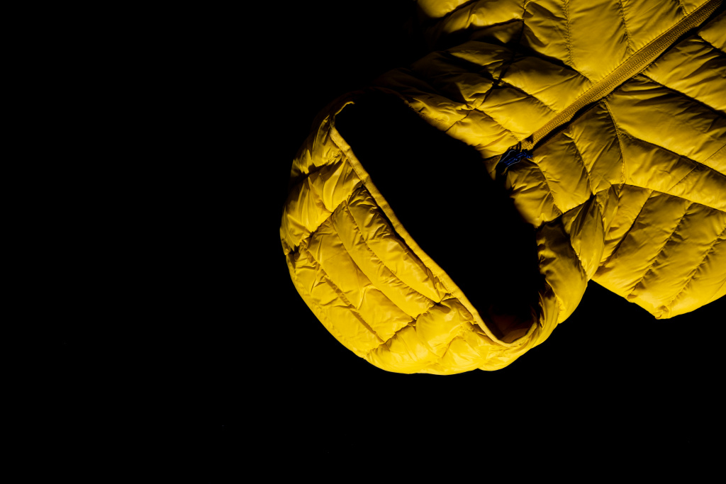 closeup-shot-of-a-yellow-down-jacket-on-black-background.jpg